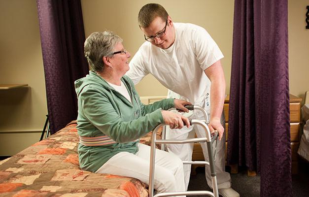 A Nursing Assistant Student Helping an Elderly Person